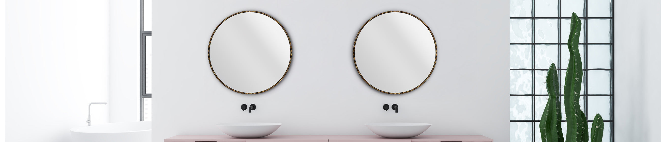 Modernes Badezimmer mit zwei runden Spiegeln über weißen Waschbecken, rosa Konsole und hoher Kaktuspflanze vor Glasbaustein-Fenster.